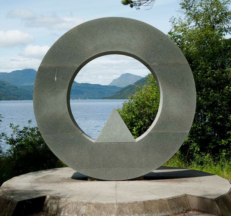 Close-up of an abstract, circular monument, overlooking Loch Lomond