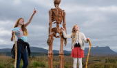 Two young girls inspect sculpture The Unknown, Borgie Glen, Sutherland