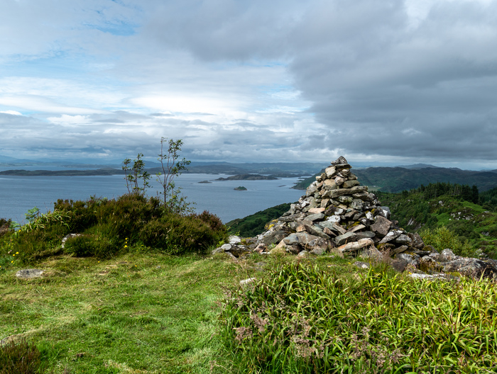 Stone monument on a hill overlooking the sea