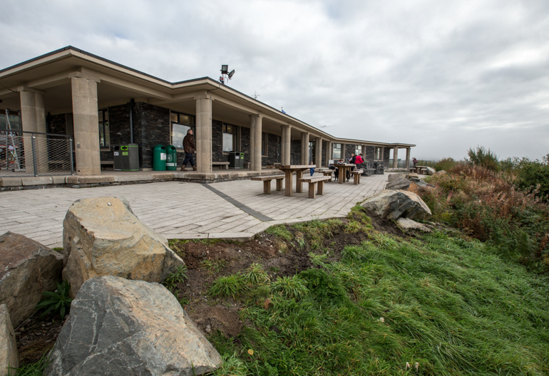 A picnic area and patio in front of The Lodge Forest Visitor Centre