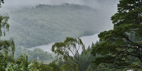 View in the mist from high hill of wooded hills and Loch Arkaig, near Fort William
