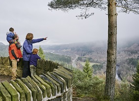 Family looking over forest from Craigvinean viewpoint