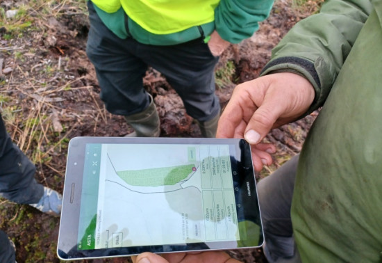A tablet in a harvesting site with a map