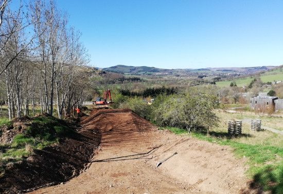 A new mountain bike trail being built under blue sky