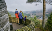 Family of two adults and two children admire view from Pine Cone Point, Craigvinean Forest, Dunkeld
