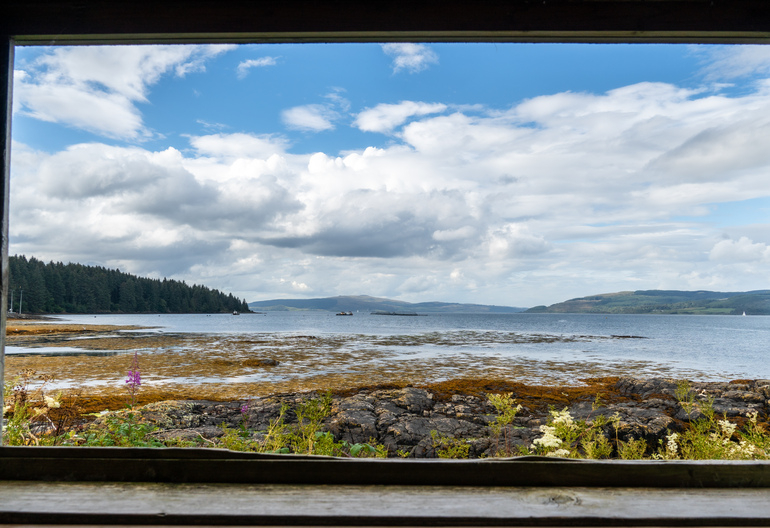 View through a wooden window onto the sea