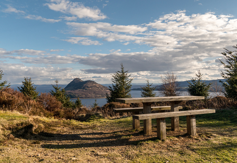 A picnic table overlooking the sea and island