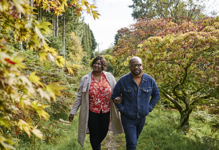 Man and woman stroll together through Kilmun Arboretum