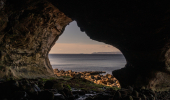 Inside of a cave looking at the sea