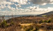 A picnic table on a hillside overlooking the sea