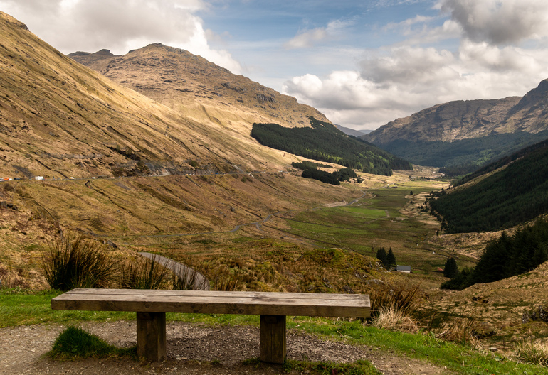 A bench at a viewpoint over a glen