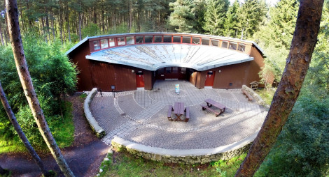 Bennachie Visitor Centre building, surrounded by conifer trees
