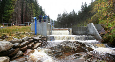 Walkers look at dam and waterfall at the Carie Hydro Scheme, Carie Hydro Scheme, Loch Rannoch, Perthshire