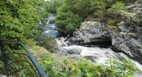 View from viewing platform down onto rapids, waterfall, gorge at Falls of Shin