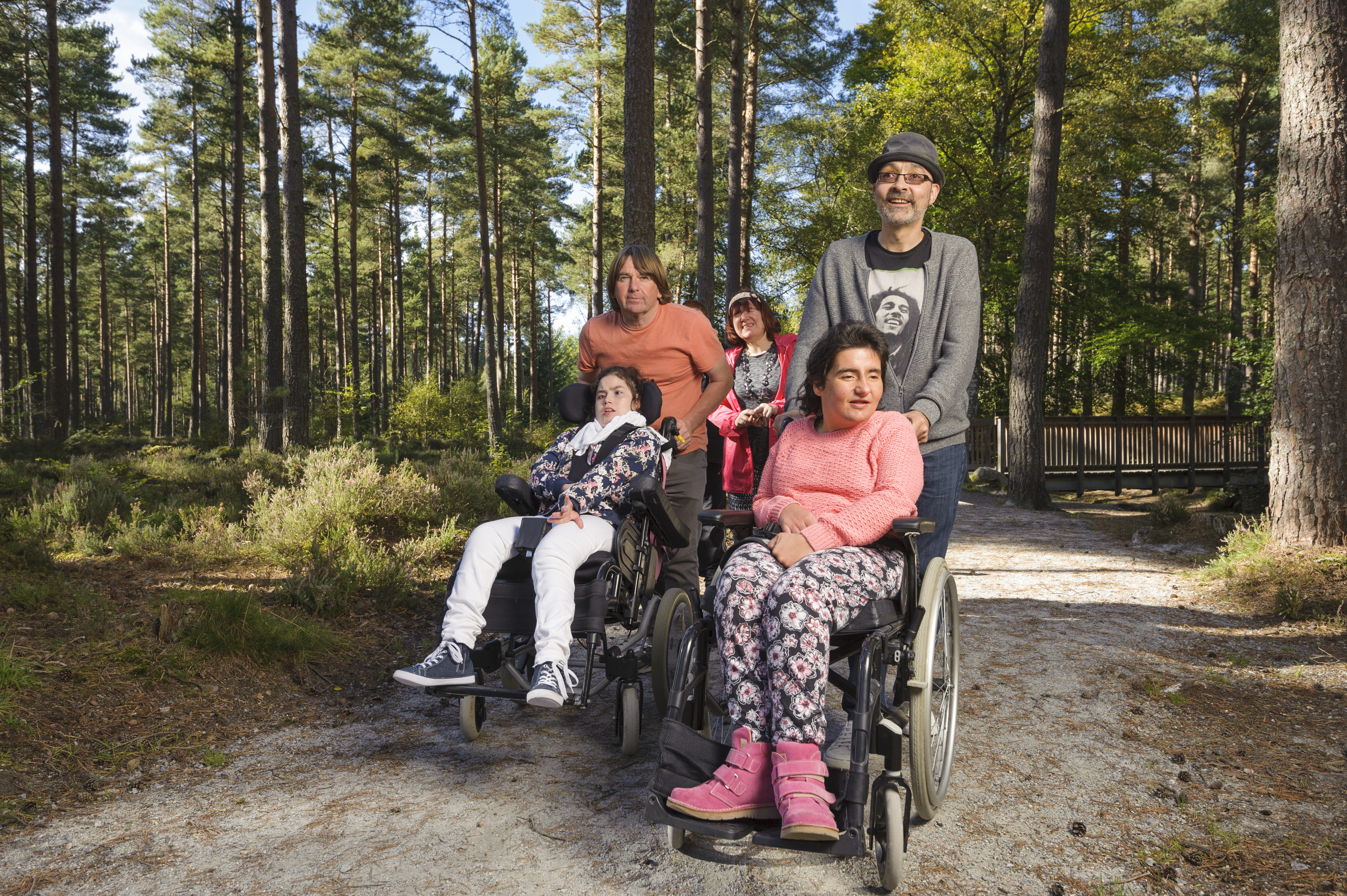 A group of caregivers and clients (in wheelchairs) stop for a picnic, near Toronto, Elgin, Moray.