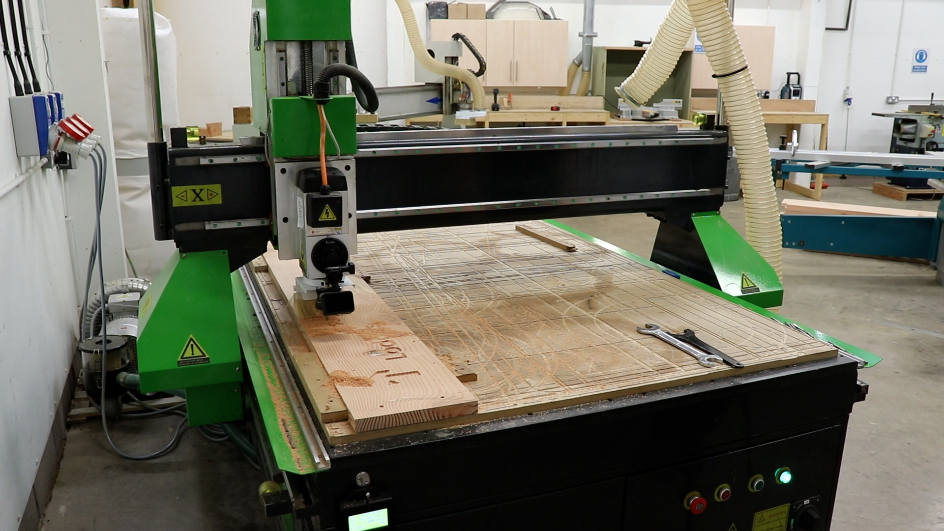 A CNC router carving a wooden board
