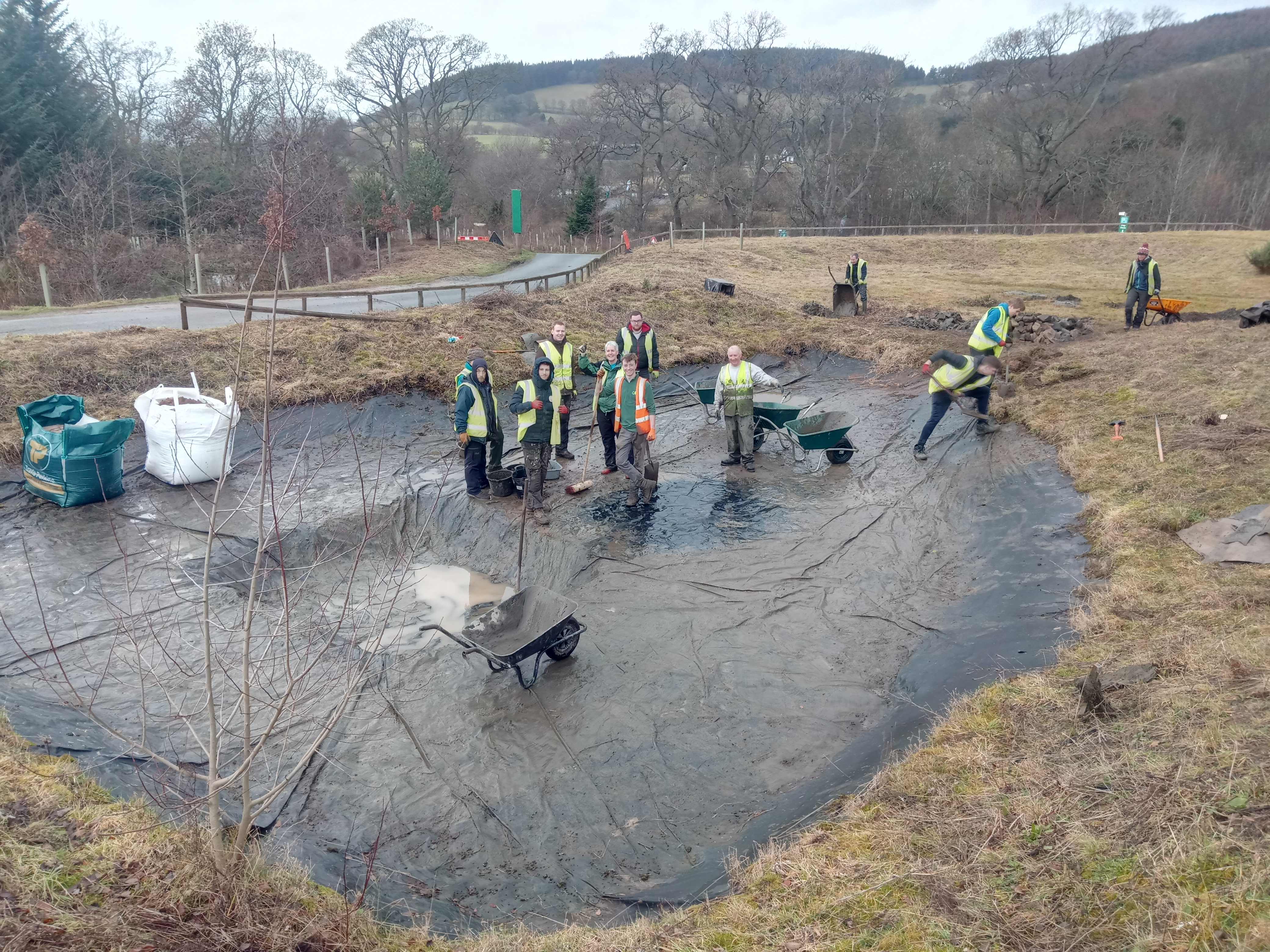 Volunteers assemble in the pond, ready for some hard graft