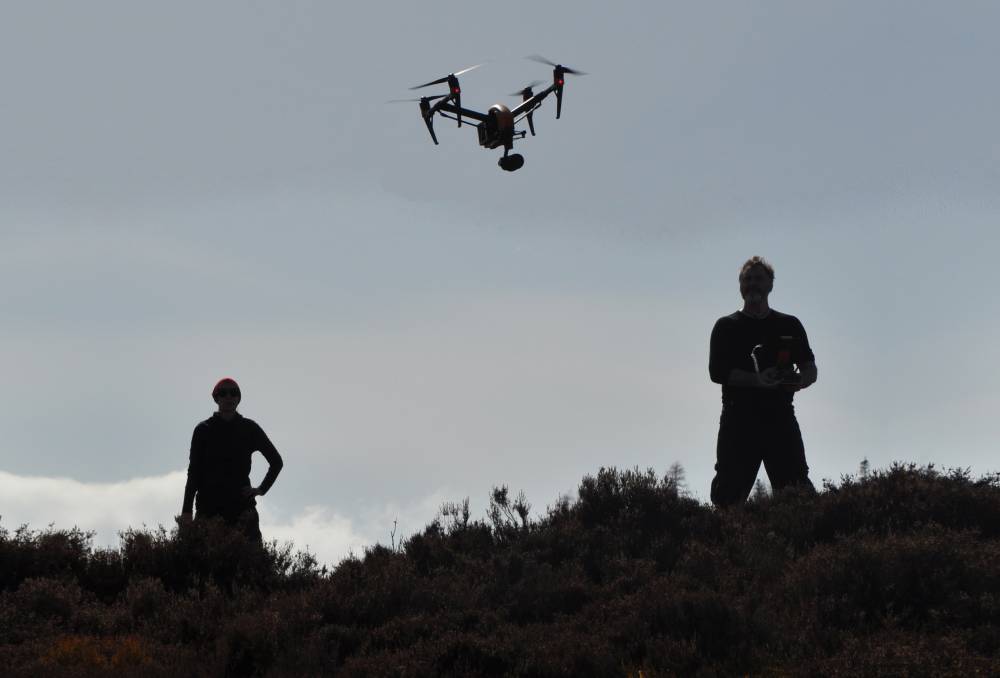 Two men flying a drone