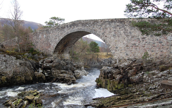 A high stone bridge over a river at Little Garve