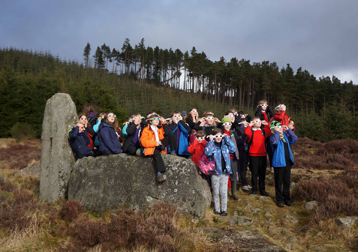 Pupils viewing the eclipse at Whitehills stone circle in 2015