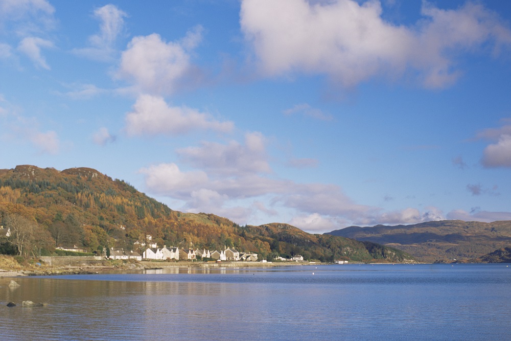 A view across a loch towards the coastal houses at the village of Tighnabruaich