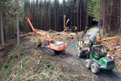 Forestry equipment on a hill surrounded by firs 