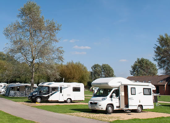 Two motorhomes at an official campsite