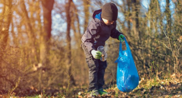 Child picking up litter and putting in a bag