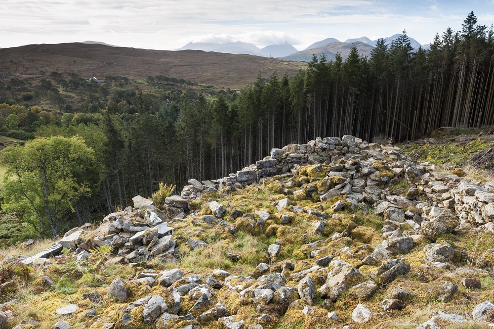 Remains of a broch on a hilltop on Raasay; the mountains of Skye in the background