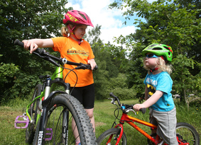 Two young children with mountain bikes