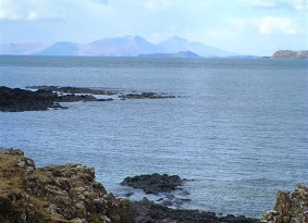 A view across the sea towards distant mountains