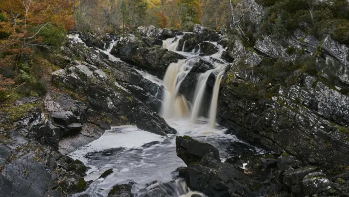 Waterfalls with trees in the background.