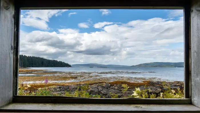 View of a coastal scene from the window of a wildlife hide.