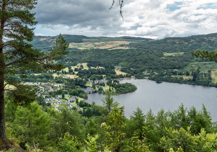 View of river Tay and a small village with trees on the hills