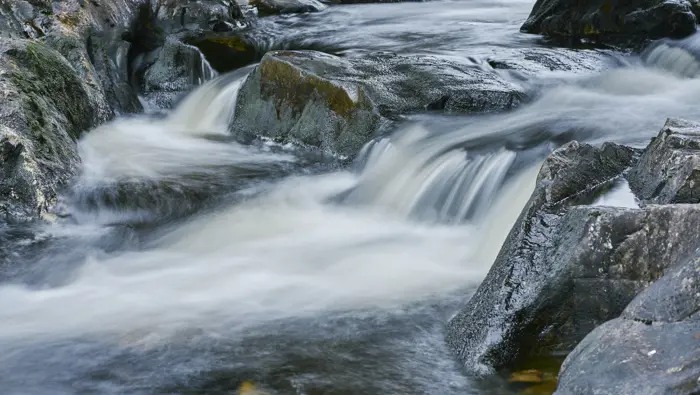 Close up of rocks and a small waterfall.