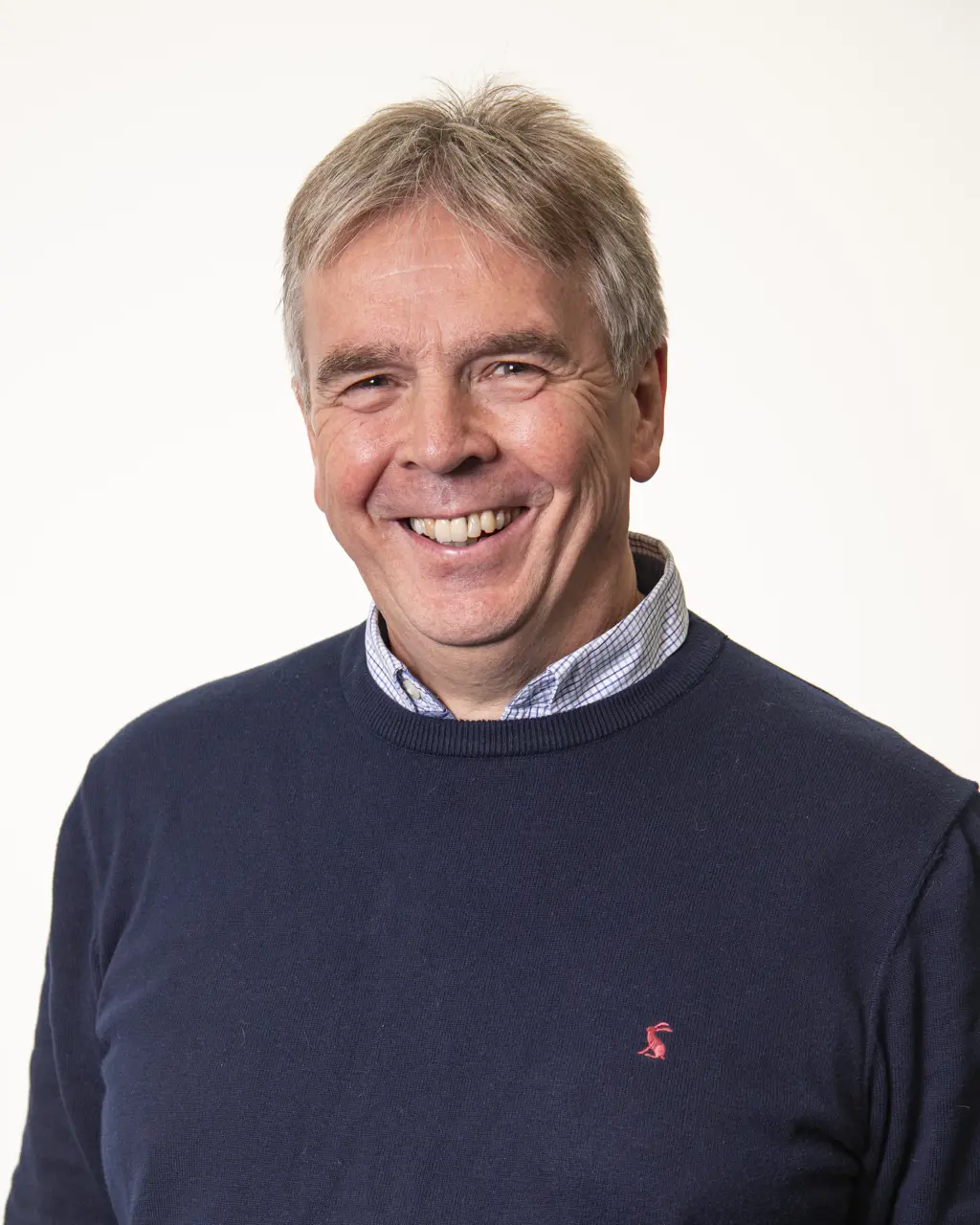 Headshot of Graeme Hutton smiling against a white background.