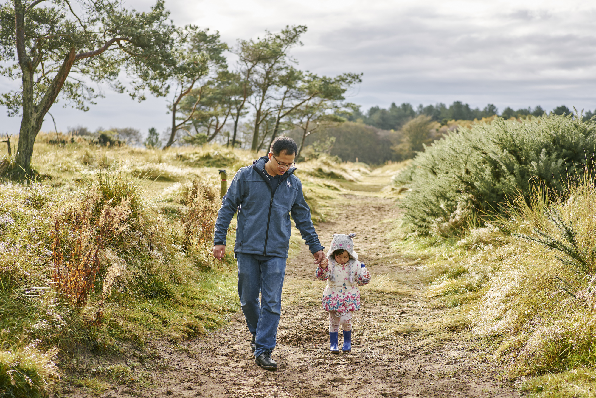  Young girl and man walking at Tentsmuir (near Leuchars) on forest trail