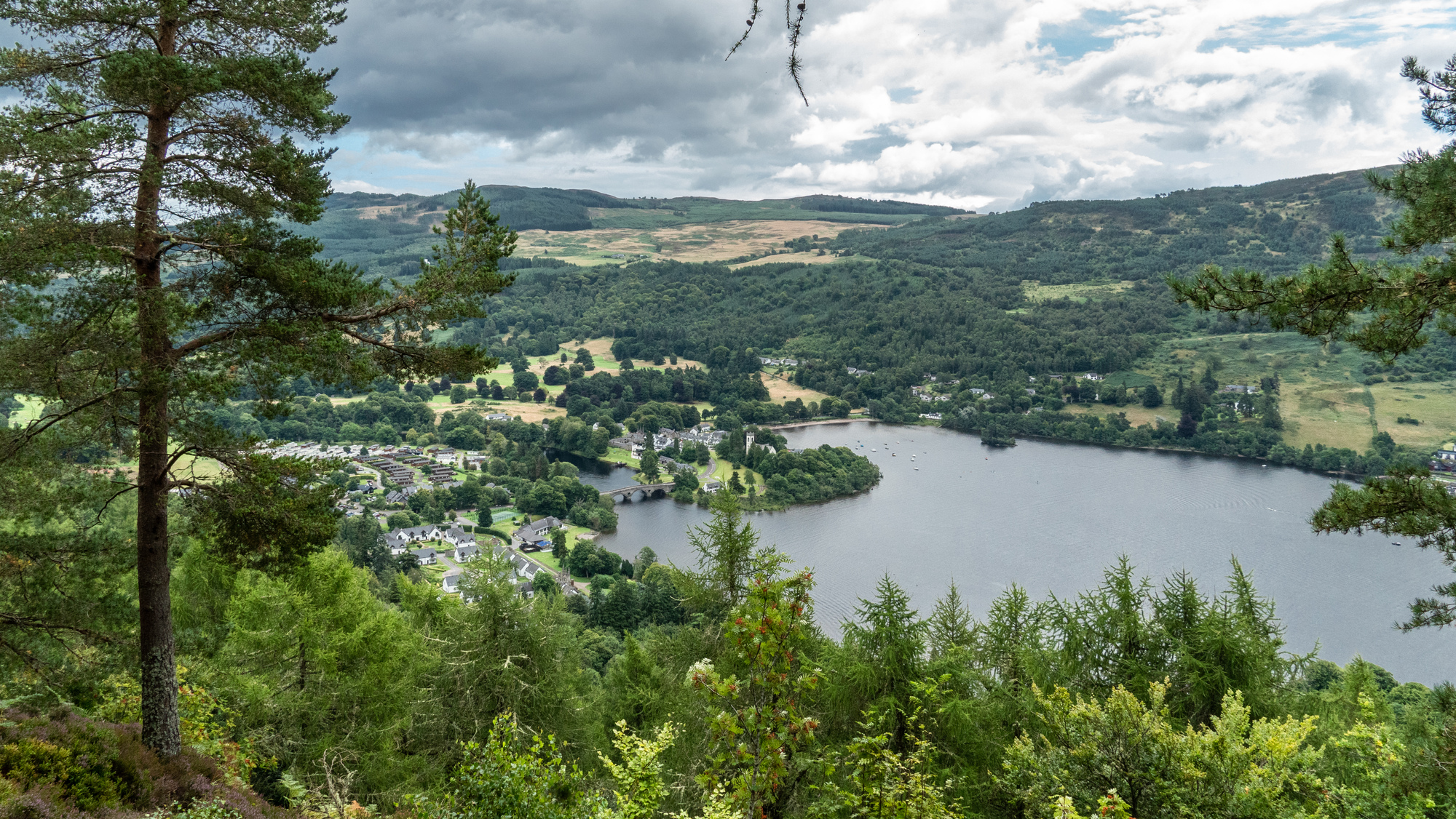  View of river Tay and a small village with trees on the hills