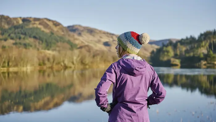 Person looking out over a loch.
