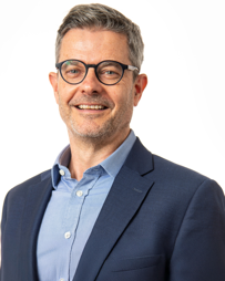 A headshot of Kevin Quinlan against a white background