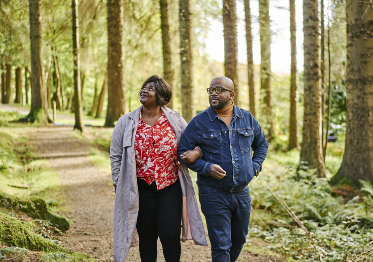 Man and woman stroll together through Kilmun Arboretum