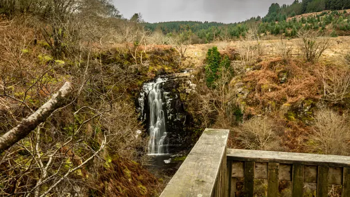 A waterfall overlooking a wooden platform in winter