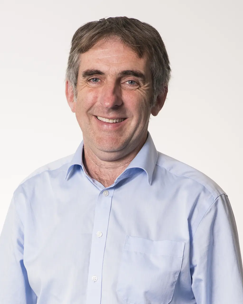 Headshot of Graeme Prest smiling against a white background.